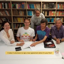 people seated in front of a bookcase